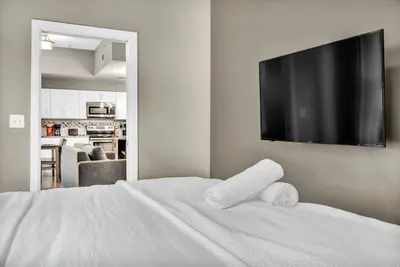 a bedroom with a white bed with two towels on it at Elegant Downtown Condo • Fitness Gym Included in Cleveland