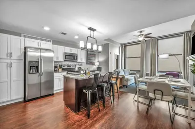a kitchen and dining room with a table and chairs at Upscale Downtown Loft | Parking • Gym in Cleveland