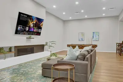 a living room with a couch and a tv at Black & Tan Bold Style Smooth Finish Served Daily in Cleveland