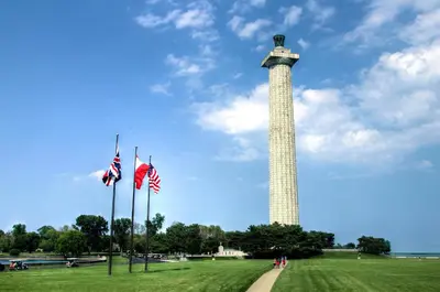 a tall tower with american flags in a field at Put-in-Bay Island Club #97 in Put-in-Bay