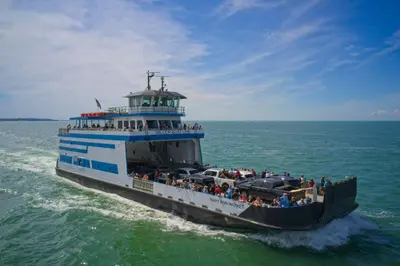a ferry boat filled with people on the water at Put-in-Bay Island Club #113 in Put-in-Bay