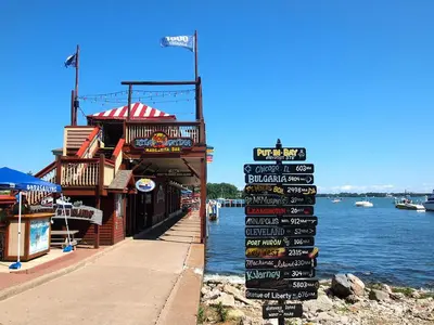 a sign for a seafood restaurant next to the water at Put-in-Bay Island Club #113 in Put-in-Bay