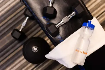 a bottle of water in a suitcase with a towel at Sonesta Simply Suites Pittsburgh Airport in Imperial
