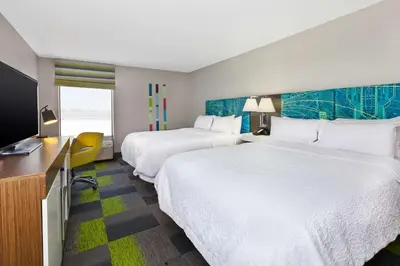 a hotel room with two beds and a flat screen tv at Hampton Inn Marysville in Marysville