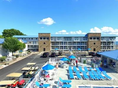 an aerial view of a resort with chairs and umbrellas at Put-in-Bay Waterfront Condo #205 in Put-in-Bay