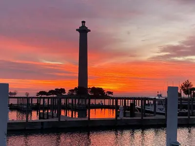 a clock tower with a sunset in the background at Put-in-Bay Waterfront Condo #206 in Put-in-Bay