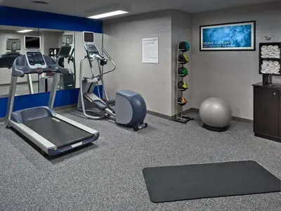 a fitness room with a treadmill and a gym at Sonesta Simply Suites Cleveland Airport in Middleburg Heights