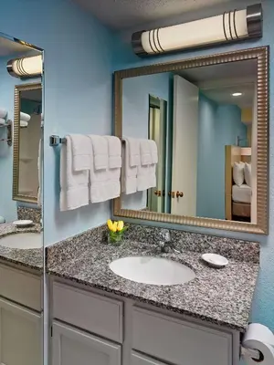 a bathroom with a sink and a mirror at Sonesta Simply Suites Cleveland Westlake in Westlake