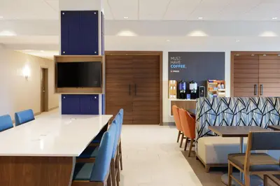 a dining room with a large table and chairs at Holiday Inn Express Hotel & Suites Cleveland-Streetsboro by IHG in Streetsboro