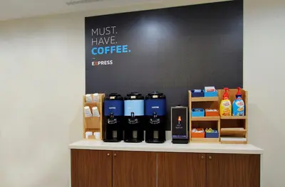 a counter with bottles of coffee on it at Holiday Inn Express Hotel & Suites Youngstown North-Warren/Niles by IHG in Warren
