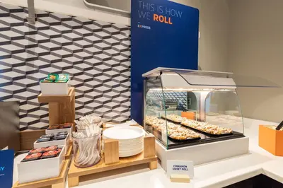 a display case with donuts and other pastries at Holiday Inn Express Hotel & Suites Youngstown North-Warren/Niles by IHG in Warren