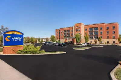 a parking lot with a sign in front of a building at Comfort Suites Florence - Cincinnati South in Florence