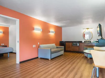 a large living room with a couch and a table at Motel 6-Columbus, OH - OSU in Columbus