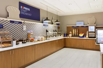 a fast food restaurant with a counter with food at Holiday Inn Express Lexington - Horse Park Area by IHG in Lexington