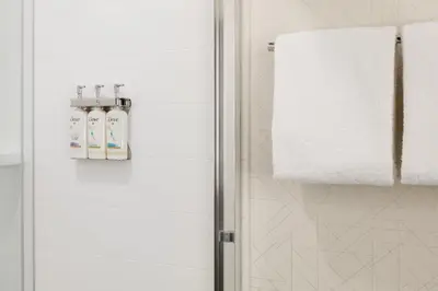a bathroom with a shower and a towel at Holiday Inn Express Lexington - Horse Park Area by IHG in Lexington