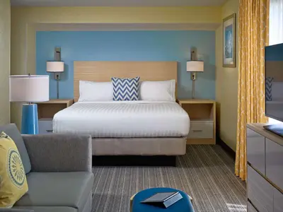 a bedroom with a bed and a couch and a chair at Sonesta ES Suites Cincinnati - Blue Ash in Blue Ash