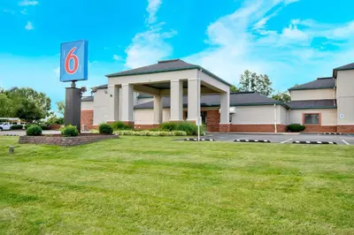 a building with a number six sign in a yard at Motel 6 - Georgetown, KY - Lexington North in Georgetown