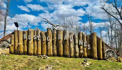a wooden fence with the words russelletts written on it at The Bunkhouse - 3 BR, 2 BA Deluxe Cabin in Genoa