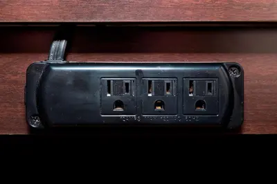 a black electrical outlet on a wooden table at Red Roof Inn Dayton - Fairborn/Nutter Center in Fairborn
