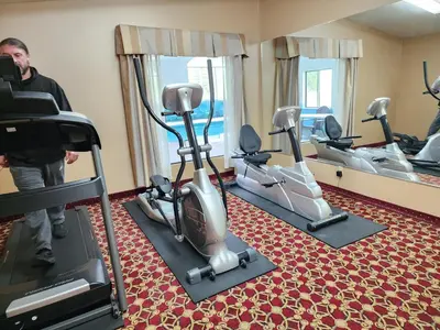 a man standing in a gym with tread machines at Quality Inn Wheelersburg in Wheelersburg