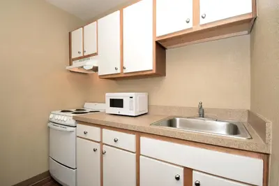 a small kitchen with a sink and a microwave at Extended Stay America Suites - Cleveland - Middleburg Heights in Middleburg Heights