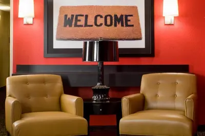 two chairs and a lamp in a waiting room at Studio 6 Extended stay Fairfield, OH - Cincinnati in Fairfield
