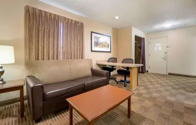 a living room with a couch and a table at Extended Stay America Suites - Toledo - Maumee in Maumee