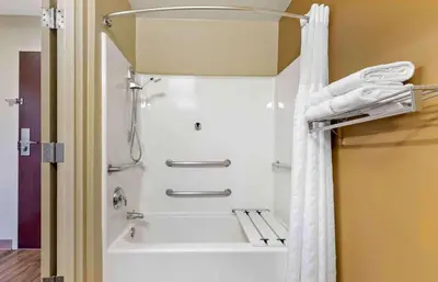a shower in a bathroom with a white shower curtain at Extended Stay America Suites - Toledo - Maumee in Maumee