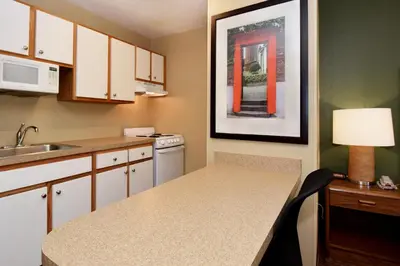 a small kitchen with a sink and a table with a lamp at Extended Stay America Suites - Pittsburgh - Airport in Imperial