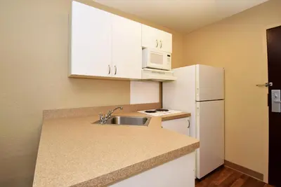 a small kitchen with a sink and a white refrigerator at Extended Stay America Suites - Columbus - NE - I-270 in Gahanna