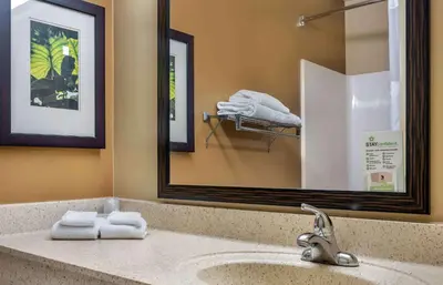 a bathroom with a sink with a mirror and towels at Extended Stay America Suites - Columbus - Dublin in Dublin
