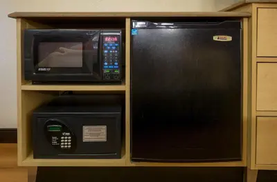 a microwave and a microwave oven in a cabinet at Red Roof Inn Charleston - Kanawha City, WV in Charleston