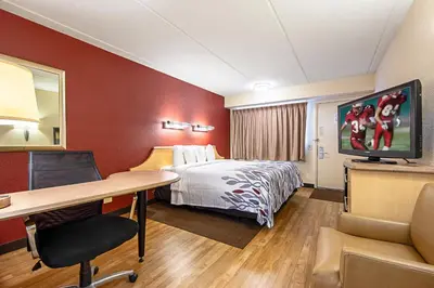 a hotel room with a bed and a desk at Red Roof Inn Toledo University in Toledo