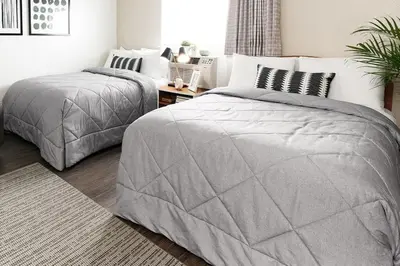 a bedroom with two twin beds and a table at InTown Suites Extended Stay Cincinnati OH - Fairfield in Fairfield