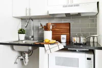 a kitchen counter with a sink and a stove at InTown Suites Extended Stay Columbus OH - I-70E Hamilton Rd in Columbus