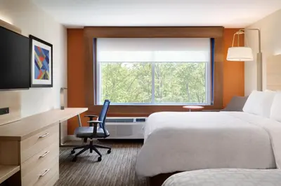 a hotel room with a bed and a desk and a window at Holiday Inn Express & Suites Heath - Newark by IHG in Heath