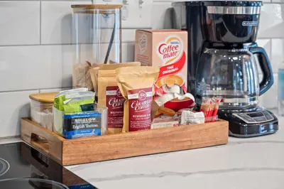 a wooden tray filled with food on a kitchen counter at 4 Apartments, Downtown, Walk to Cincy Stadiums! in Covington