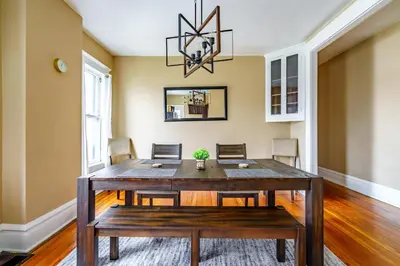 a dining room with a wooden table and chairs at Jungle House Luxury Stays - Columbus Downtown Short North in Columbus