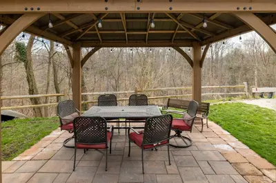 a patio with a table and chairs under a pavilion at Georgetown Villas 2-1c King and Queen Bedrooms ideal for long stays! in Fairview Park