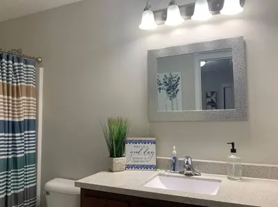 a bathroom with a sink and a mirror at Diamond in the Rough-696 in Middletown