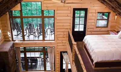 a bedroom in a log cabin with a bed at Treehouse #3 by Amish Country Lodging in Millersburg