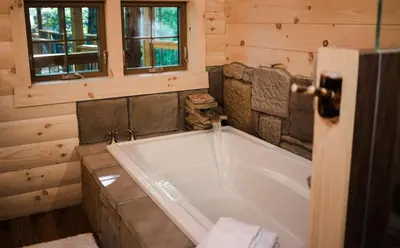 a bathroom with a large tub in a cabin at Skyview Treehouse by Amish Country Lodging in Millersburg
