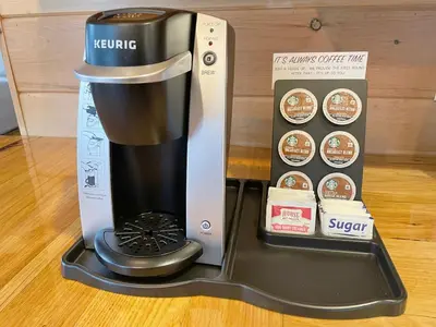 a coffee maker next to a box and a coffee maker at Cricket Hill Treehouse by Amish Country Lodging in Millersburg