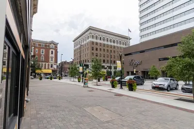 a city street with cars parked on the street at Spacious 1 bed 1 bath Downtown OTR condo minutes walk to the Reds Bengals stadium & more! in Cincinnati