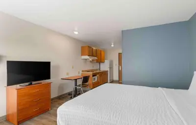 a bedroom with a bed and a desk with a television at Extended Stay America Select Suites - Cleveland - Airport in Cleveland