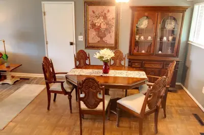 a dining room with a table and chairs at Cheerful 3-BR home near Downtown Dayton, Wright Patterson AFB and Airport in Dayton