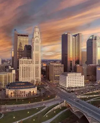 a city skyline with a highway in front of buildings at The Village Townhouse - 5 BR in Columbus