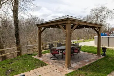 a wooden gazebo with a table and chairs at Courtyard View near Valley 2-2a Georgetown Villas in Fairview Park