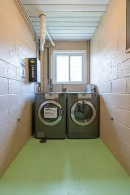 a laundry room with two washing machines in it at Courtyard View near Valley 2-2a Georgetown Villas in Fairview Park