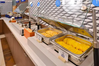 a buffet line with trays of food on display at Holiday Inn Express Fairfield by IHG in Fairfield
